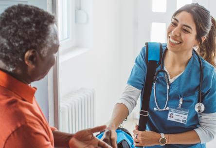 A man shaking hands with a nurse
