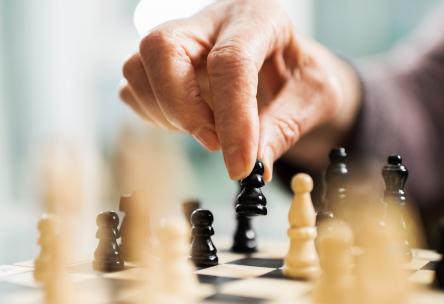 A hand moving a chess piece.