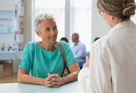 A woman talking to a doctor.