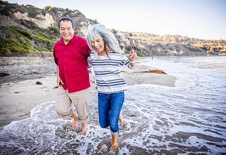 A couple walking on the beach.