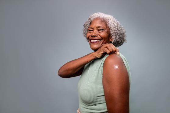 A woman with a bandage on her arm.